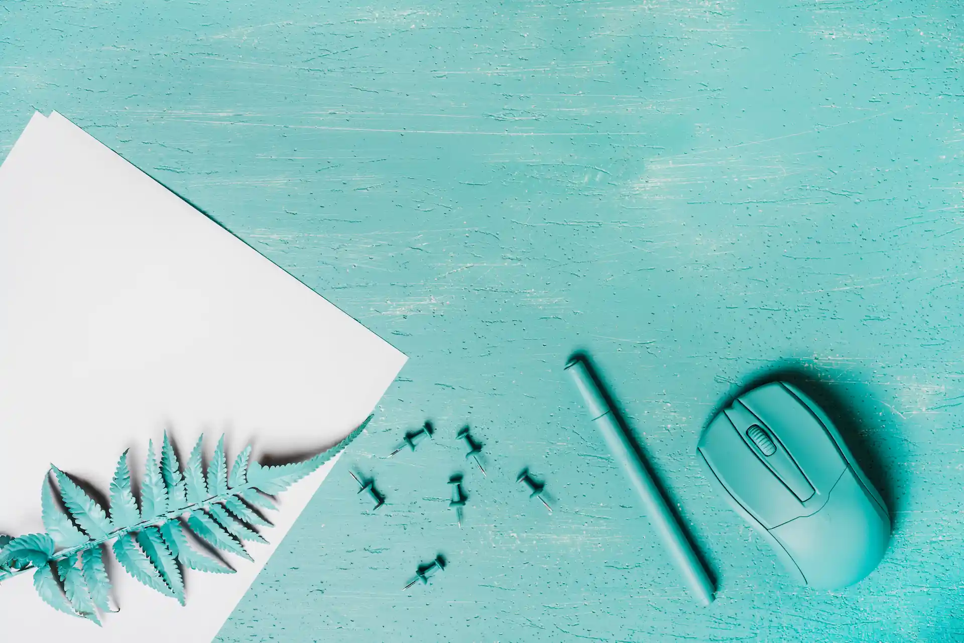 turquoise-colored-pen-mouse-fern-leaves-push-pins-wooden-surface