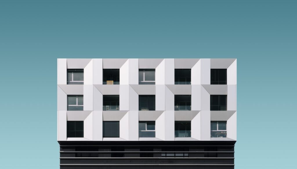 Low angle shot of a metal silver and black modern building under the blue sky