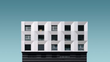 Low angle shot of a metal silver and black modern building under the blue sky