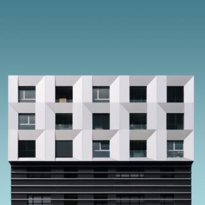 Low angle shot of a metal silver and black modern building under the blue sky