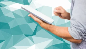 businessman-with-tablet-geometric-background